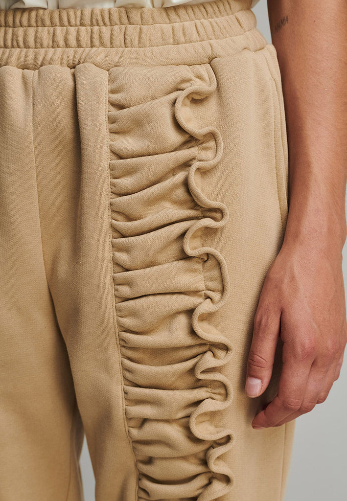 Ruffled sweatpants in camel. Features an crinkled effect, and elastic waistband and ankle cuffs. True to size.