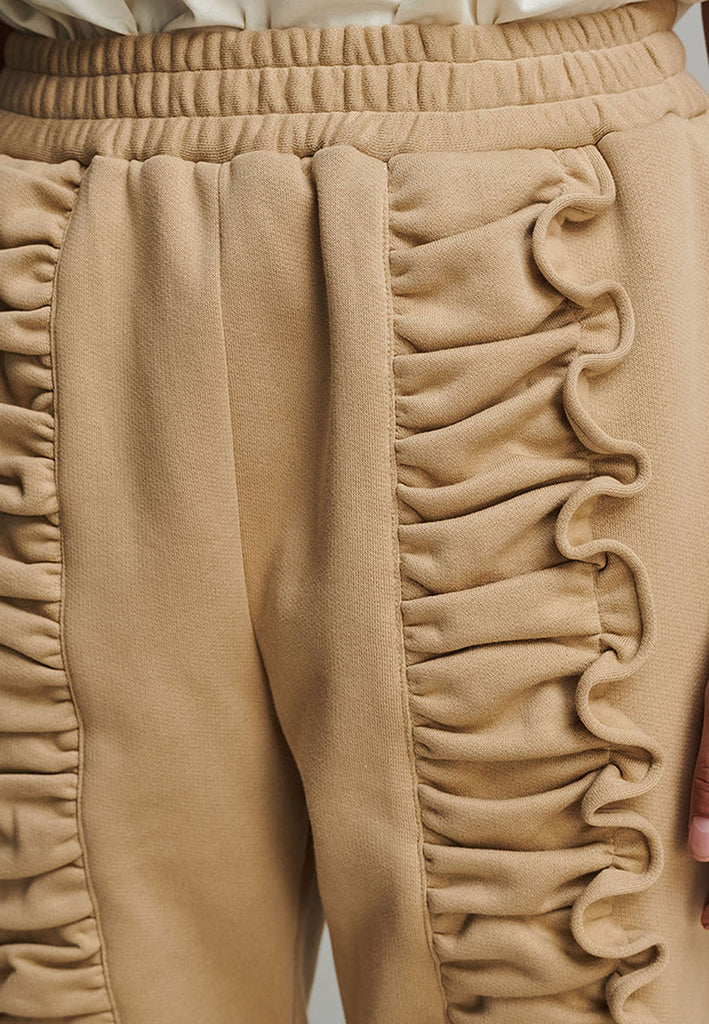 Ruffled sweatpants in camel. Features an crinkled effect, and elastic waistband and ankle cuffs. True to size.