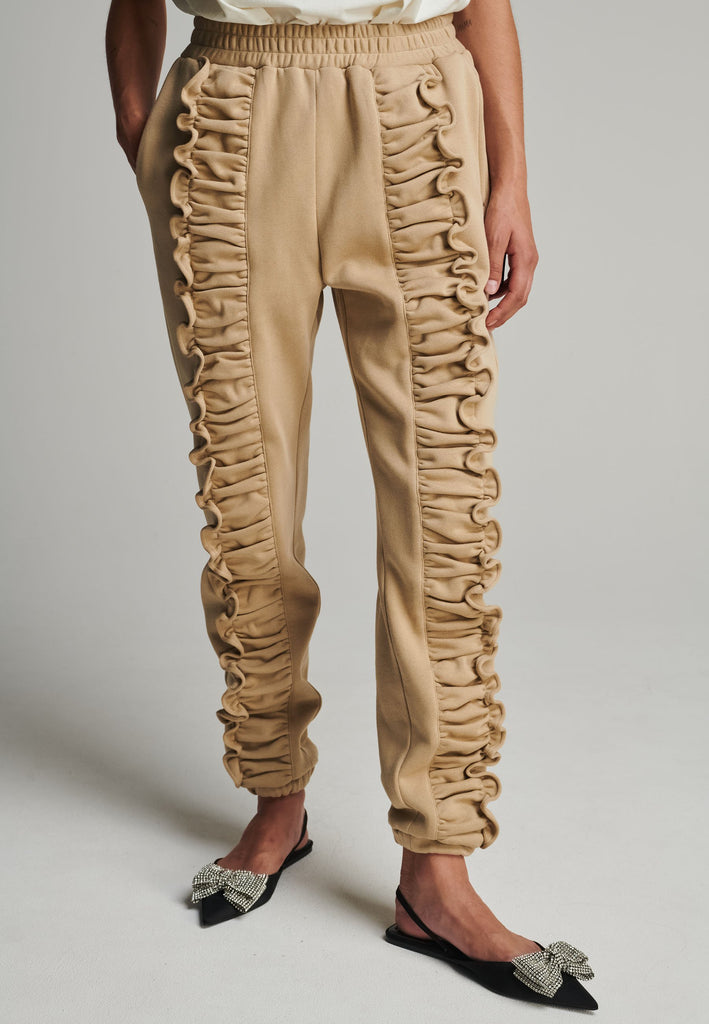 Ruffled sweatpants in camel. Features an crinkled effect, and elastic waistband and ankle cuffs. True to size.
