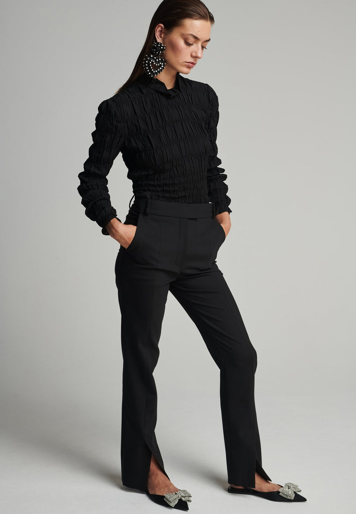 Slim pants in black. Features pockets, belt loops, pressed front pleats, and na ankle opening. True to size.
