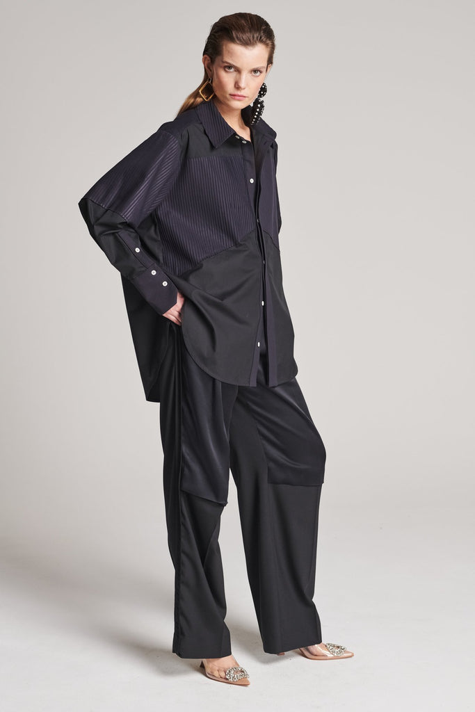 Menswear-inspired shirt. Features plisse details at the top front panel and back. Detailed with a classic collar stand, a concealed button fly-front and a string belt to adjust to your liking. Fits oversize.