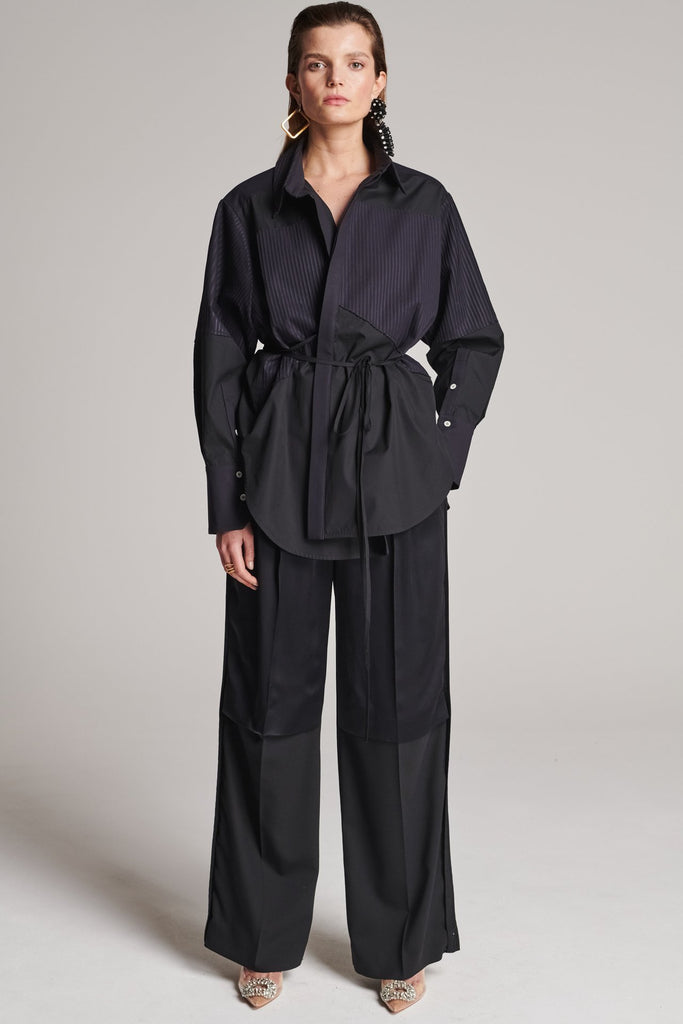 Menswear-inspired shirt. Features plisse details at the top front panel and back. Detailed with a classic collar stand, a concealed button fly-front and a string belt to adjust to your liking. Fits oversize.