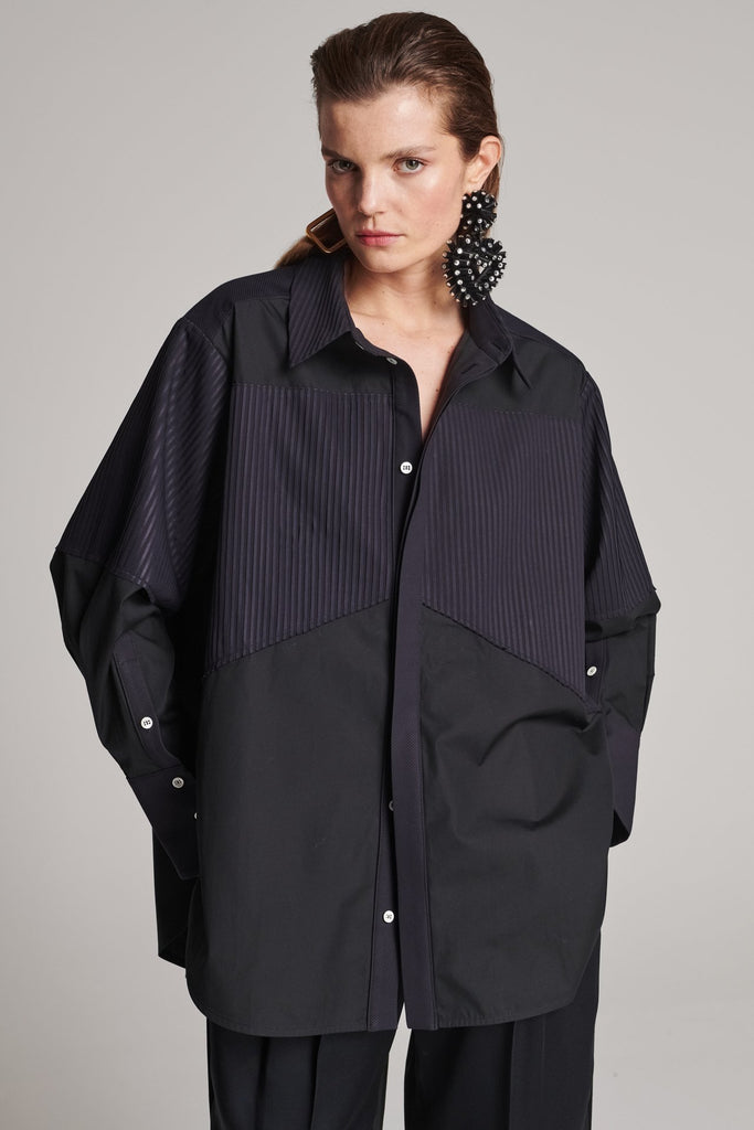 Menswear-inspired shirt. Features plisse details at the top front panel and back. Detailed with a classic collar stand, a concealed button fly-front and a string belt to adjust to your liking. Fits oversize.