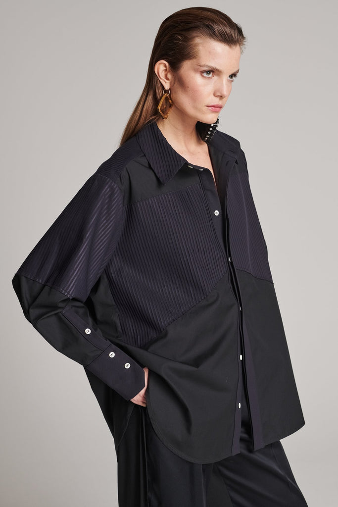 Menswear-inspired shirt. Features plisse details at the top front panel and back. Detailed with a classic collar stand, a concealed button fly-front and a string belt to adjust to your liking. Fits oversize.