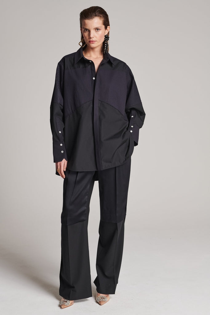 Menswear-inspired shirt. Features plisse details at the top front panel and back. Detailed with a classic collar stand, a concealed button fly-front and a string belt to adjust to your liking. Fits oversize.