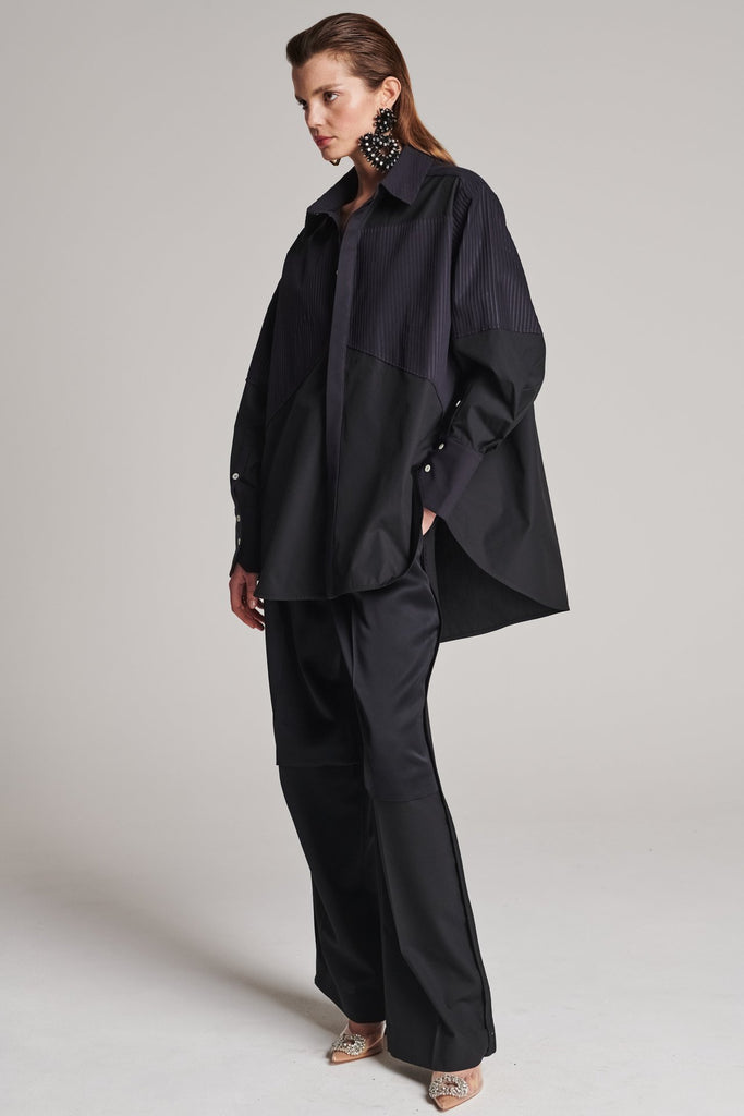 Menswear-inspired shirt. Features plisse details at the top front panel and back. Detailed with a classic collar stand, a concealed button fly-front and a string belt to adjust to your liking. Fits oversize.