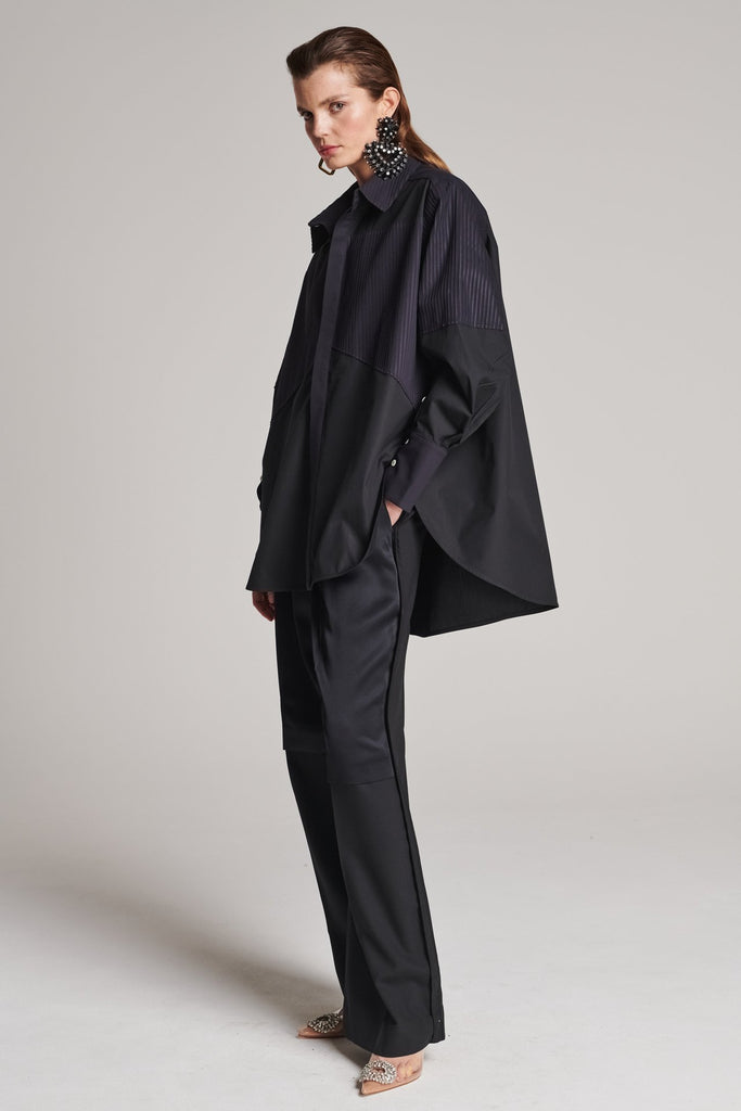 Menswear-inspired shirt. Features plisse details at the top front panel and back. Detailed with a classic collar stand, a concealed button fly-front and a string belt to adjust to your liking. Fits oversize.