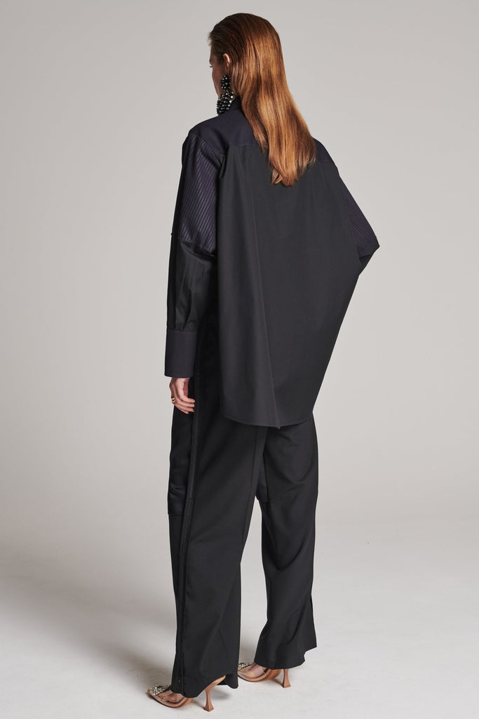 Menswear-inspired shirt. Features plisse details at the top front panel and back. Detailed with a classic collar stand, a concealed button fly-front and a string belt to adjust to your liking. Fits oversize.