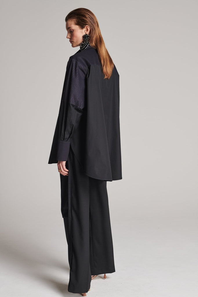 Menswear-inspired shirt. Features plisse details at the top front panel and back. Detailed with a classic collar stand, a concealed button fly-front and a string belt to adjust to your liking. Fits oversize.