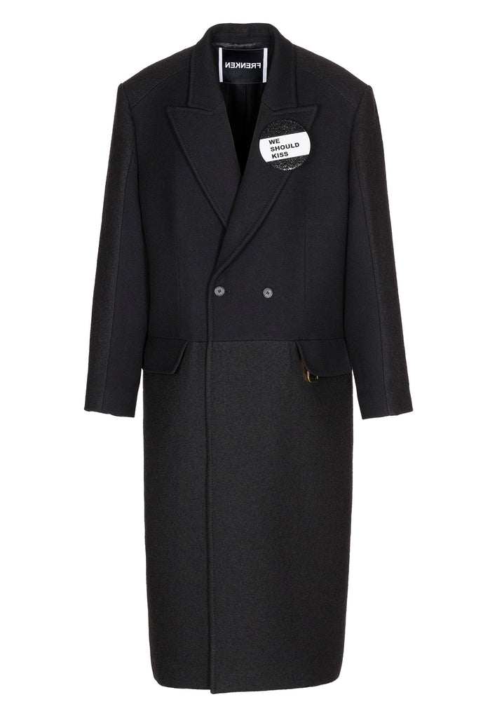 Wide-shouldered coat that combines two fabrics. Features exaggerated long sleeves and pockets. Fits oversized.