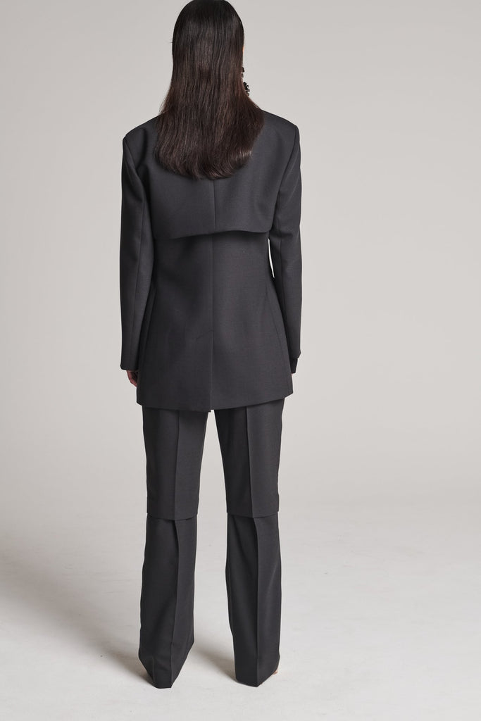 Shoulder-padded fitted blazer. Features a double layer at the front top panel and back. True to size.