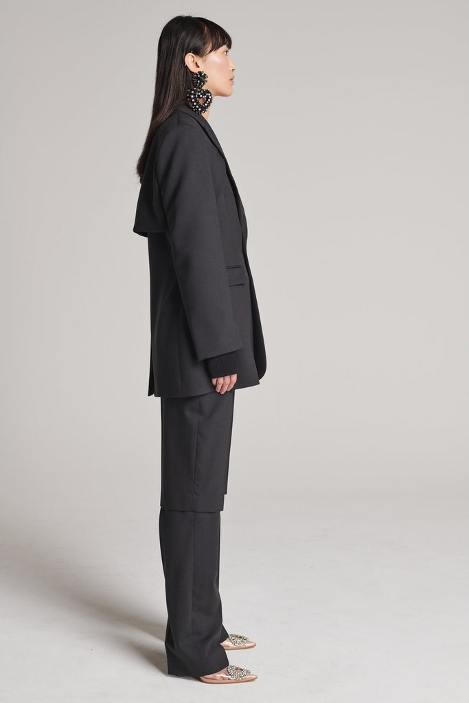 Shoulder-padded fitted blazer. Features a double layer at the front top panel and back. True to size.