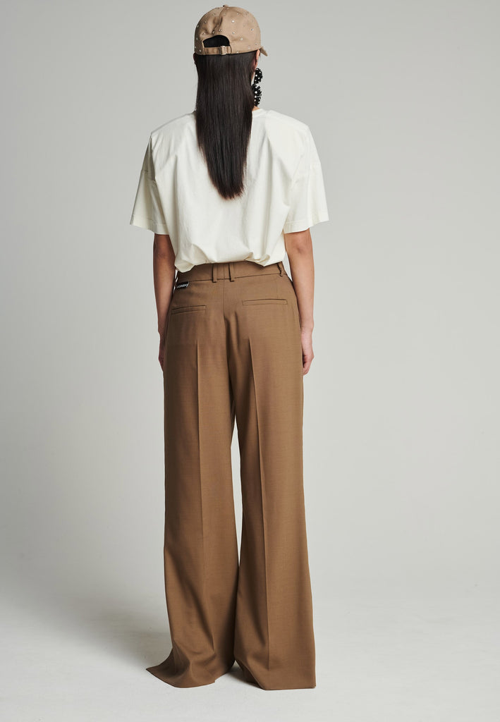 Wide-leg braided pants in camel. Features pockets, belt loops, and deep openings connected by strings. Fits oversize.