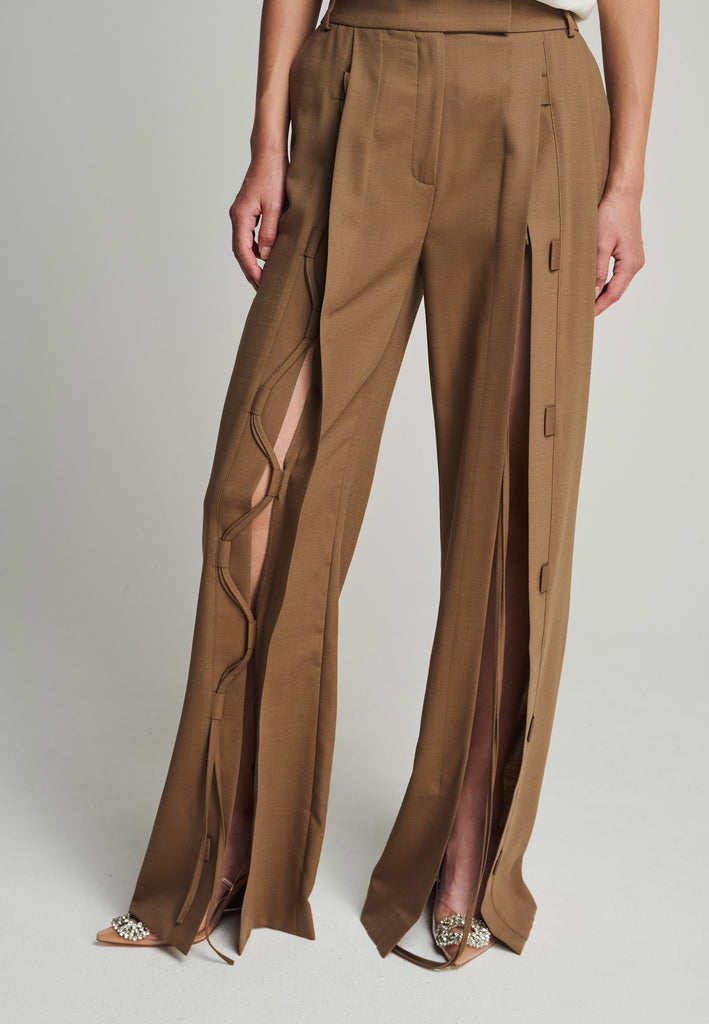 Wide-leg braided pants in camel. Features pockets, belt loops, and deep openings connected by strings. Fits oversize.