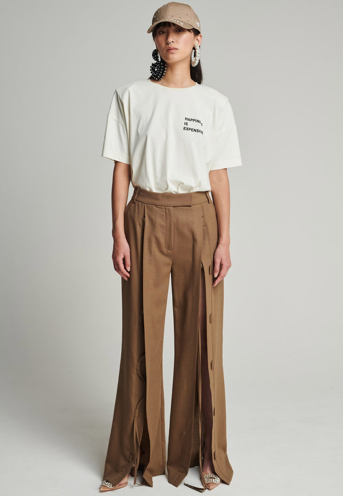 Wide-leg braided pants in camel. Features pockets, belt loops, and deep openings connected by strings. Fits oversize.