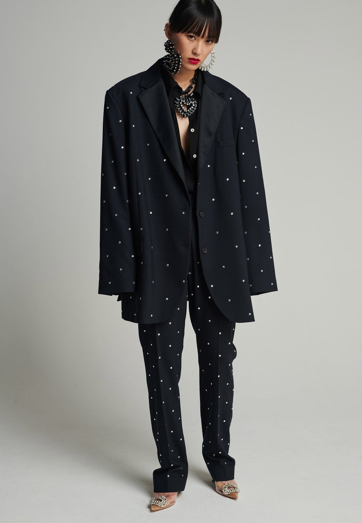 Wide-shouldered blazer in navy. Features sprinkled Swarovski diamonds, shoulder pads, pockets, and exaggerated long sleeves. Fits super oversize.