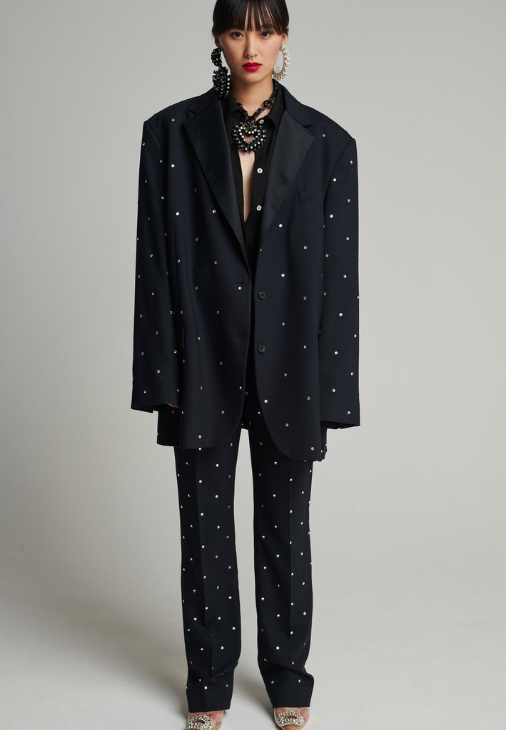 Wide-shouldered blazer in navy. Features sprinkled Swarovski diamonds, shoulder pads, pockets, and exaggerated long sleeves. Fits super oversize.