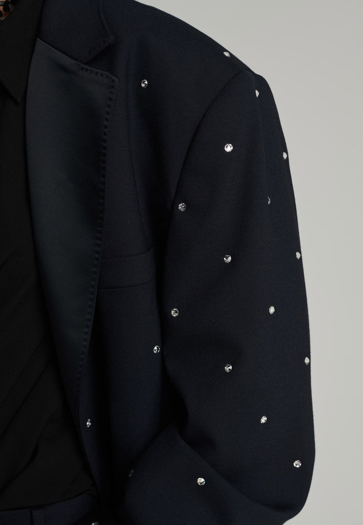 Wide-shouldered blazer in navy. Features sprinkled Swarovski diamonds, shoulder pads, pockets, and exaggerated long sleeves. Fits super oversize.