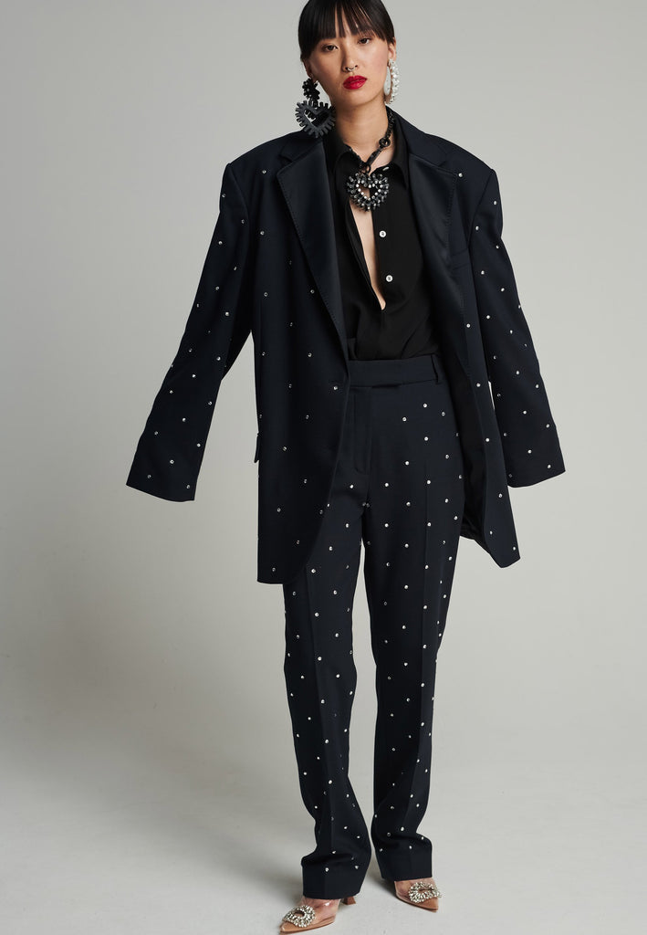 Wide-shouldered blazer in navy. Features sprinkled Swarovski diamonds, shoulder pads, pockets, and exaggerated long sleeves. Fits super oversize.