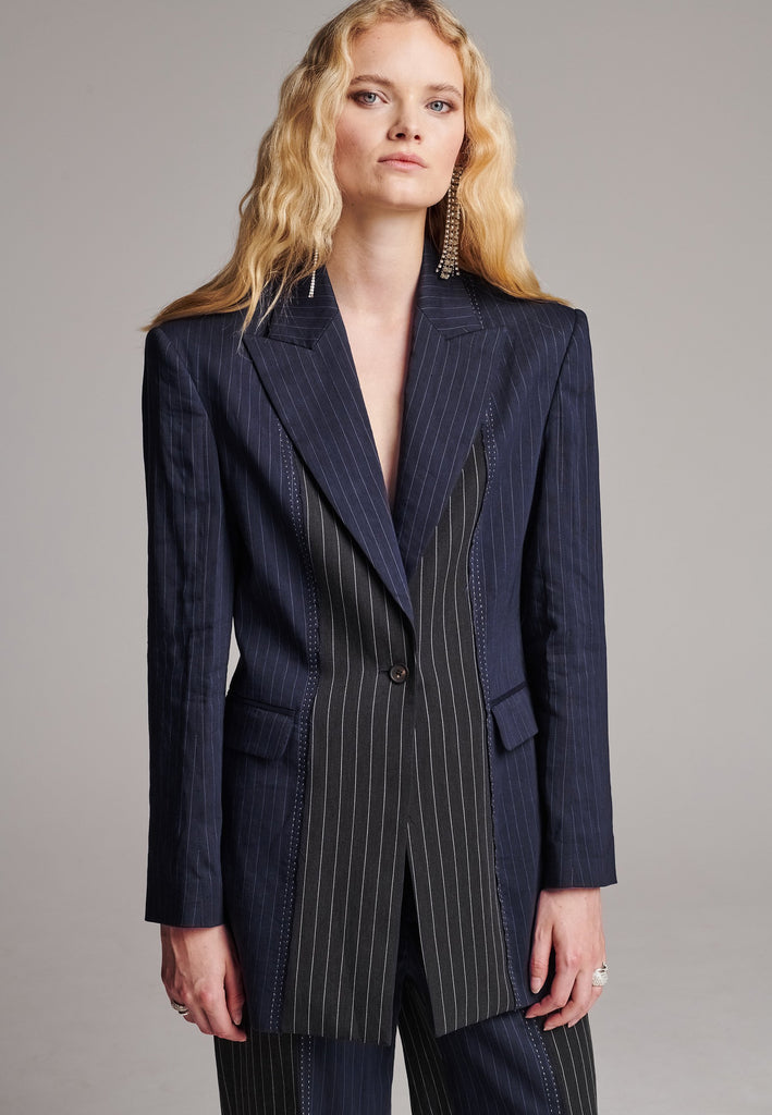 Slim sharp blazer cut from two faintly pinstriped linen blends. Detailed with flap pockets and horn button closure.