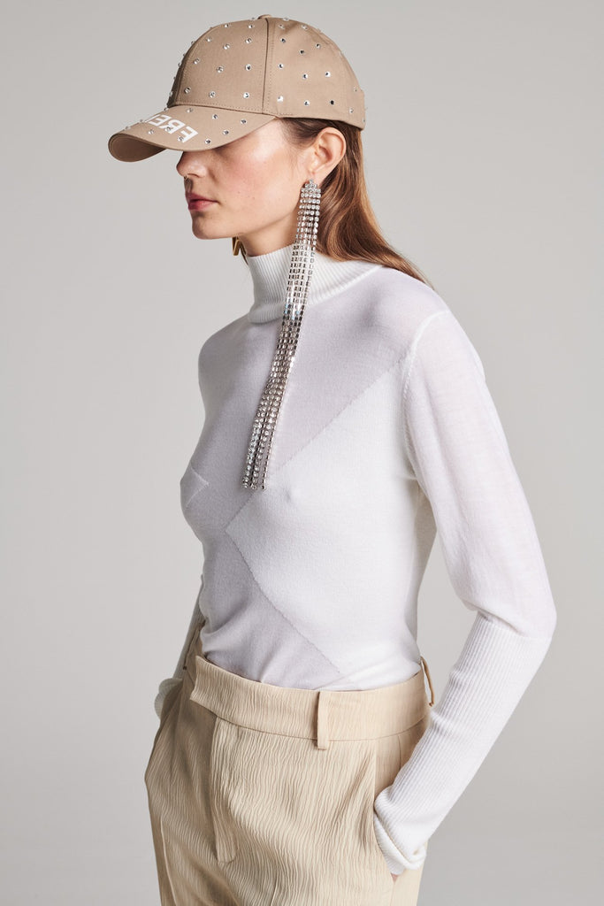 Knitted top in merino wool. Features a turtleneck, asymmetric front details and a stretchy effect for complete comfort. True to size.