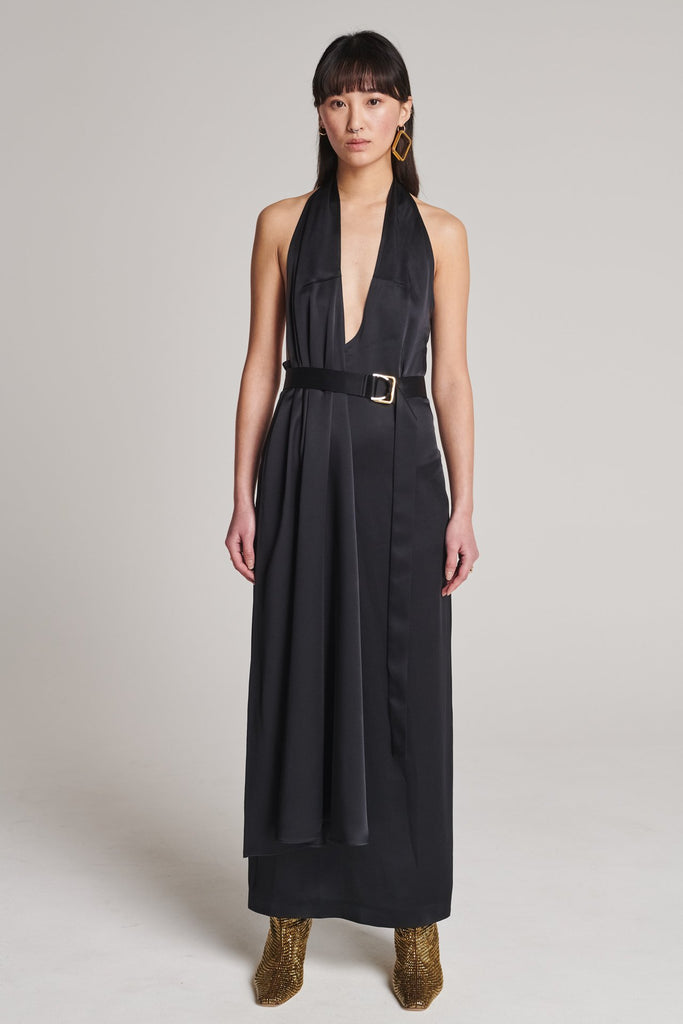 Asymmetric maxi halter dress in satin crepe. Features asymmetric details, a long right panel, a back slit and an adjustable belt with a silver and gold buckle. True to size.