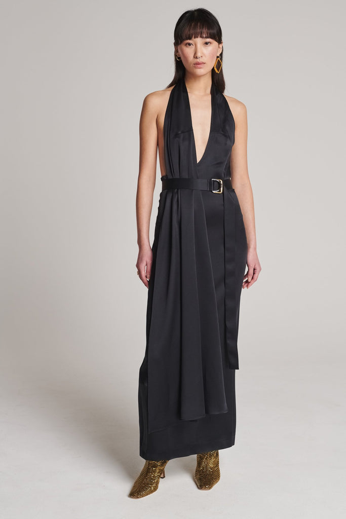 Asymmetric maxi halter dress in satin crepe. Features asymmetric details, a long right panel, a back slit and an adjustable belt with a silver and gold buckle. True to size.