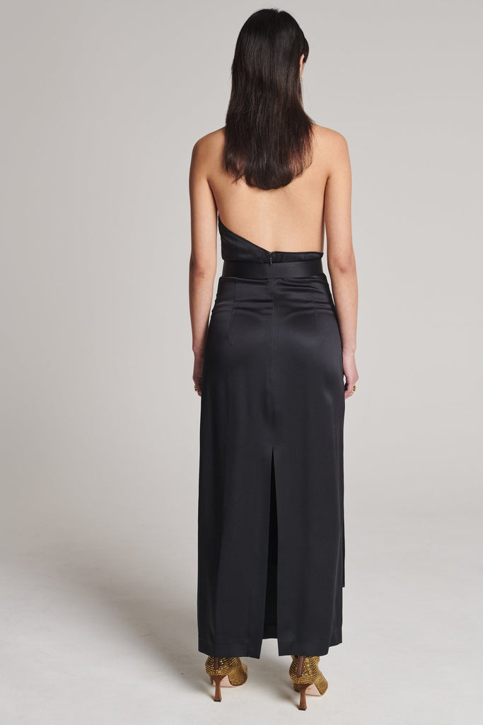 Asymmetric maxi halter dress in satin crepe. Features asymmetric details, a long right panel, a back slit and an adjustable belt with a silver and gold buckle. True to size.