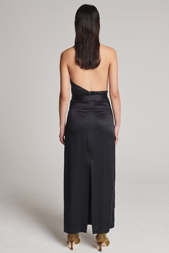 Asymmetric maxi halter dress in satin crepe. Features asymmetric details, a long right panel, a back slit and an adjustable belt with a silver and gold buckle. True to size.