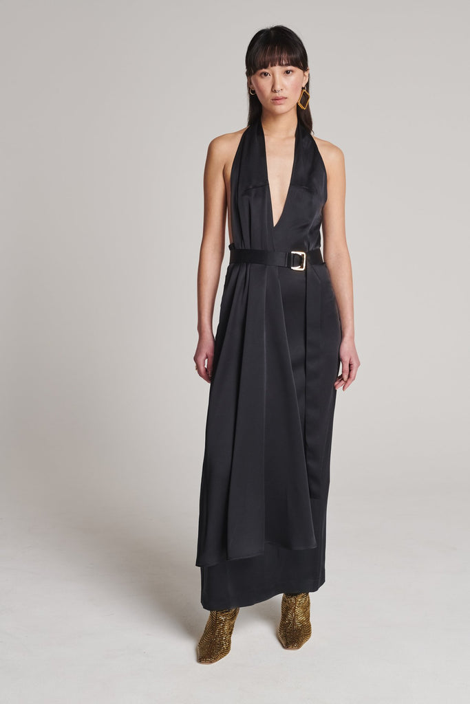 Asymmetric maxi halter dress in satin crepe. Features asymmetric details, a long right panel, a back slit and an adjustable belt with a silver and gold buckle. True to size.