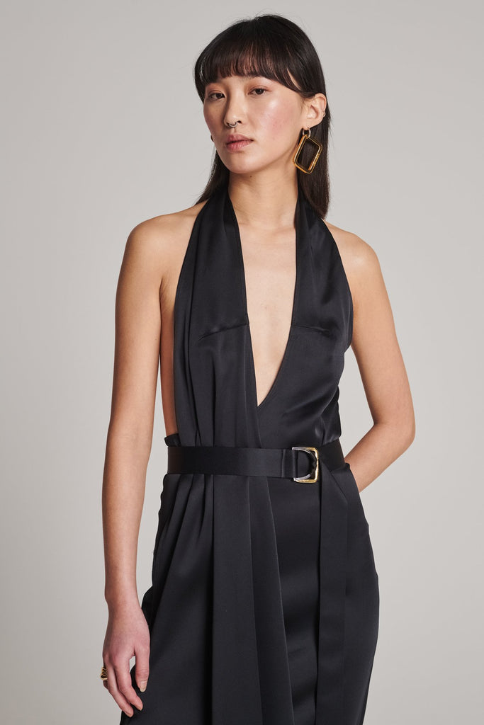 Asymmetric maxi halter dress in satin crepe. Features asymmetric details, a long right panel, a back slit and an adjustable belt with a silver and gold buckle. True to size.