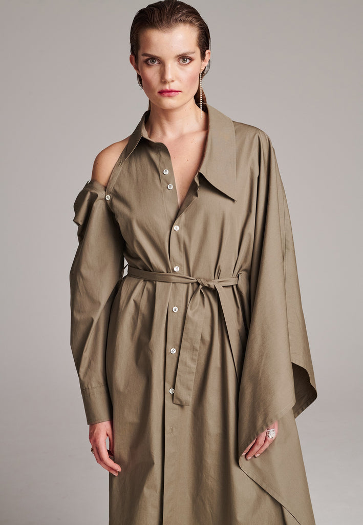 This Square asymmetric shirt-dress is an elegant choice for special events as well as your casual go-to. Can be unbuttoned for a big slit at one side that can give a sophisticated sexy look. Asymmetric collar structure. One big kimono sleeve, one detachable button-off sleeve. Designed for a relaxed/oversized fit. Use the tie belt to cinch in at the waist. Detailed with six-hole buttons. Cut from crispy 100% cotton poplin. Made in Lithuania.