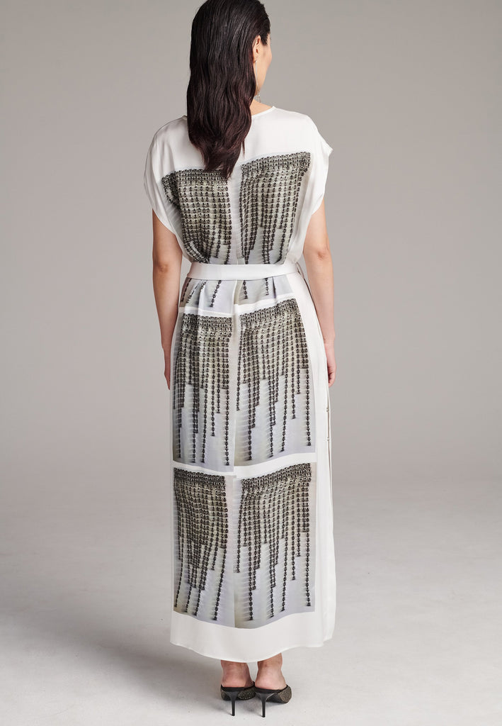 Maxi satin dress. Detailed with a digital print, side slits and a belt to cinch at the waist. 