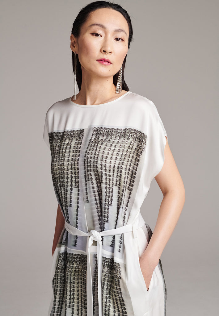Maxi satin dress. Detailed with a digital print, side slits and a belt to cinch at the waist. 