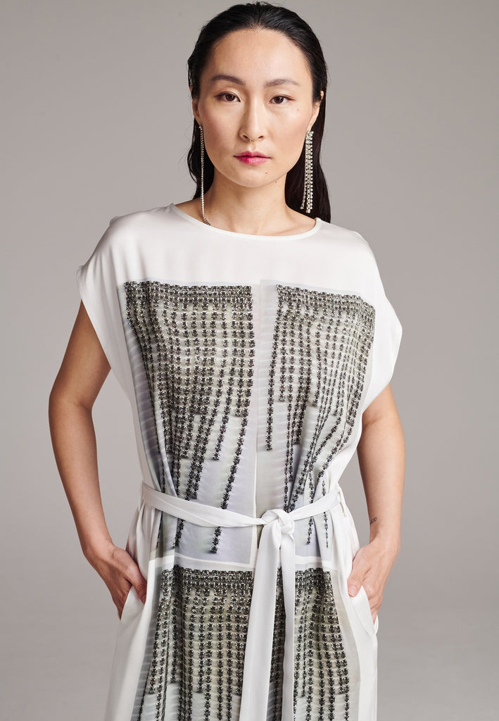 Maxi satin dress. Detailed with a digital print, side slits and a belt to cinch at the waist. 