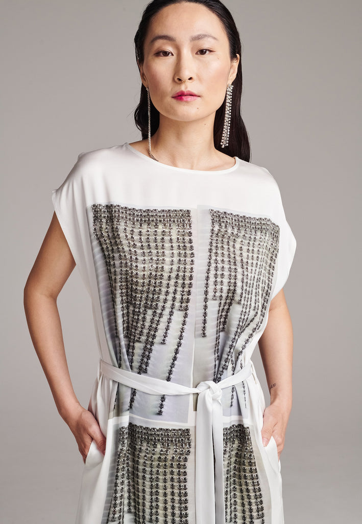 Maxi satin dress. Detailed with a digital print, side slits and a belt to cinch at the waist. 
