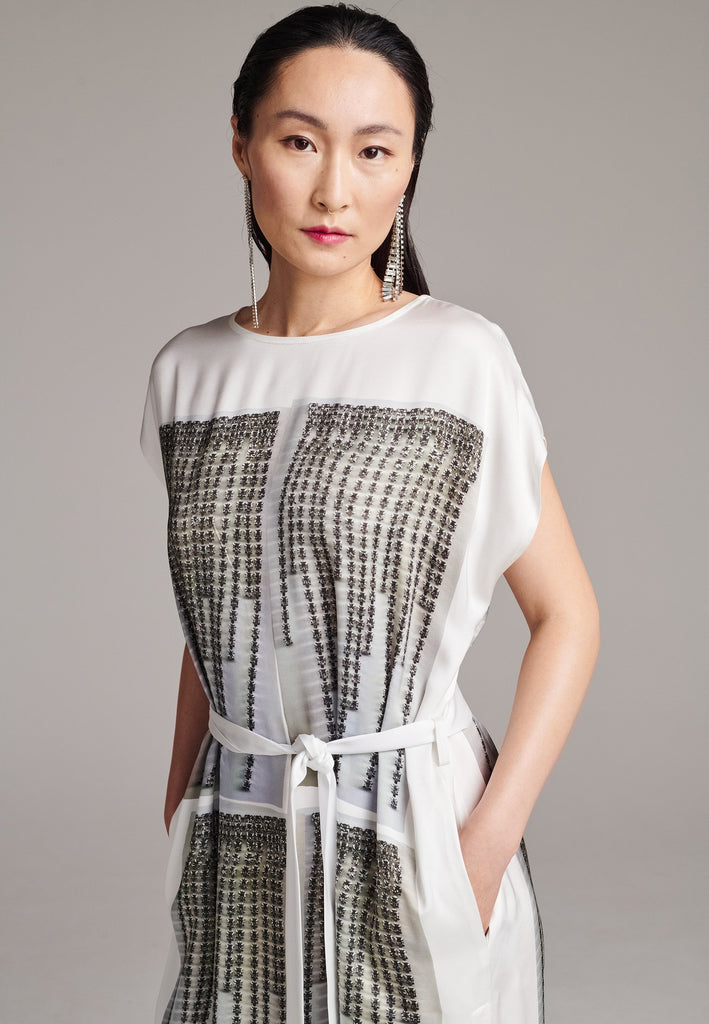 Maxi satin dress. Detailed with a digital print, side slits and a belt to cinch at the waist. 