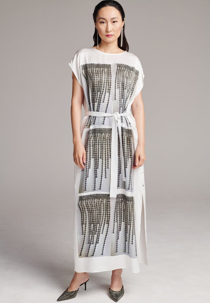 Maxi satin dress. Detailed with a digital print, side slits and a belt to cinch at the waist. 