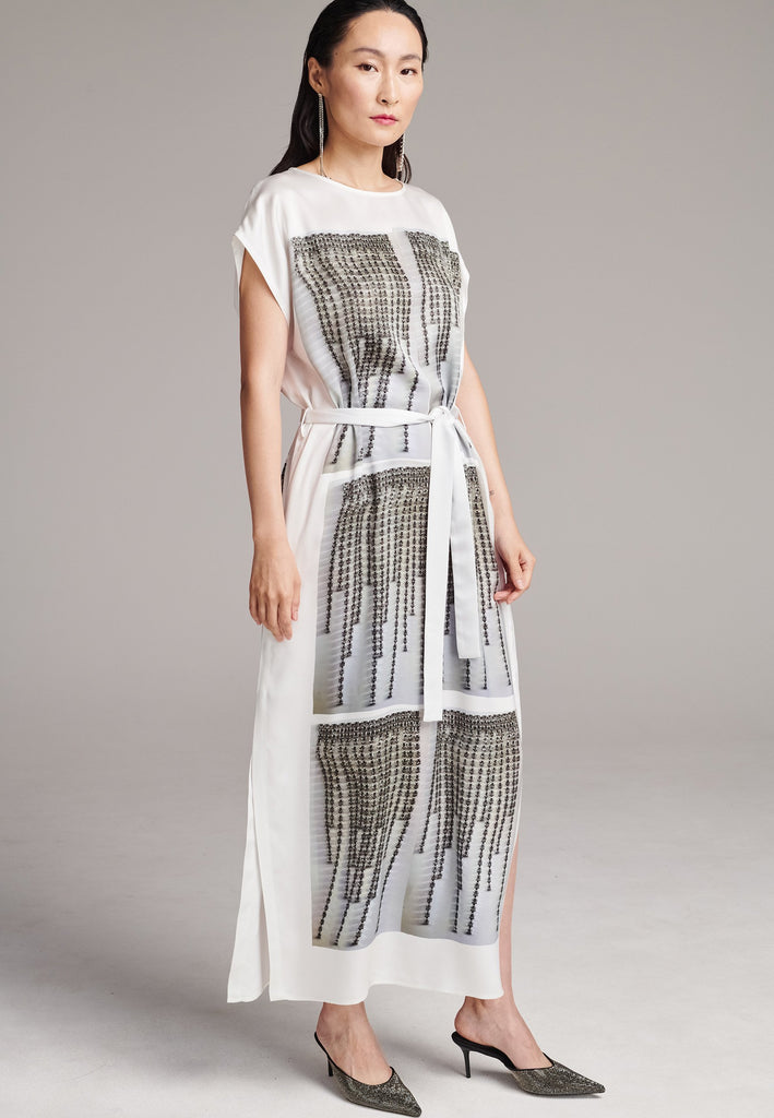 Maxi satin dress. Detailed with a digital print, side slits and a belt to cinch at the waist. 