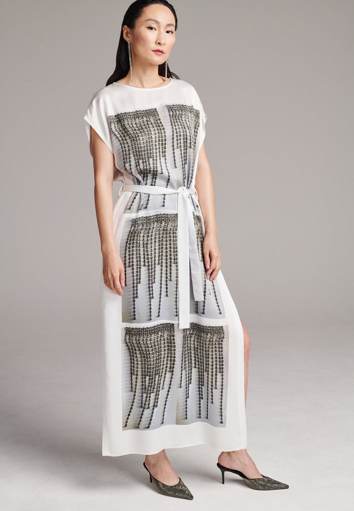 Maxi satin dress. Detailed with a digital print, side slits and a belt to cinch at the waist. 