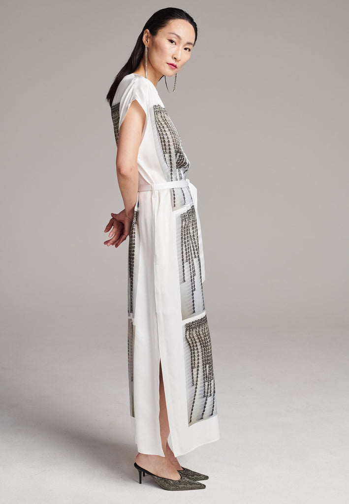 Maxi satin dress. Detailed with a digital print, side slits and a belt to cinch at the waist. 
