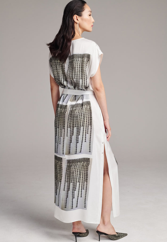 Maxi satin dress. Detailed with a digital print, side slits and a belt to cinch at the waist. 