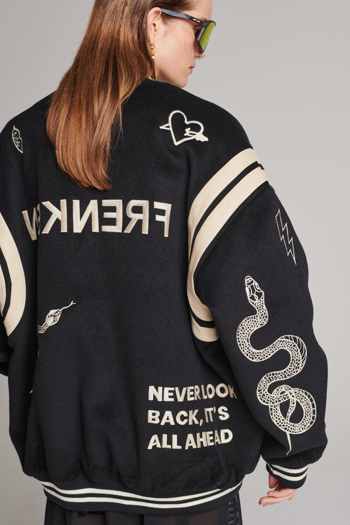 Wide-shouldered baseball jacket. Features unique designs all-over, stamped logo on the back, press buttons, leather shoulder straps, pockets, elasticated cuffs and waistband. Fits oversized.