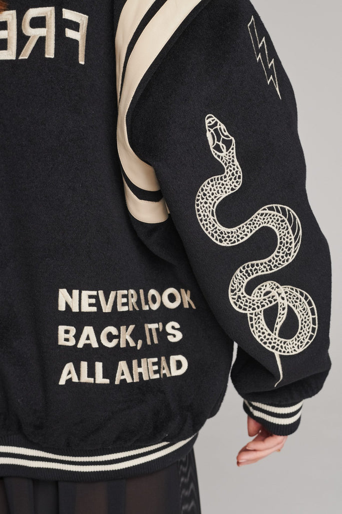 Wide-shouldered baseball jacket. Features unique designs all-over, stamped logo on the back, press buttons, leather shoulder straps, pockets, elasticated cuffs and waistband. Fits oversized.