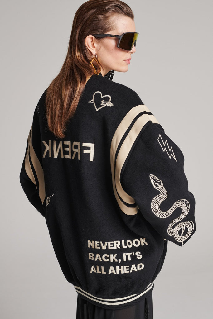 Wide-shouldered baseball jacket. Features unique designs all-over, stamped logo on the back, press buttons, leather shoulder straps, pockets, elasticated cuffs and waistband. Fits oversized.