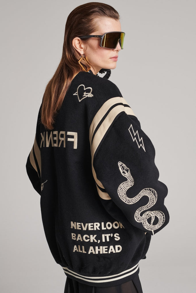 Wide-shouldered baseball jacket. Features unique designs all-over, stamped logo on the back, press buttons, leather shoulder straps, pockets, elasticated cuffs and waistband. Fits oversized.