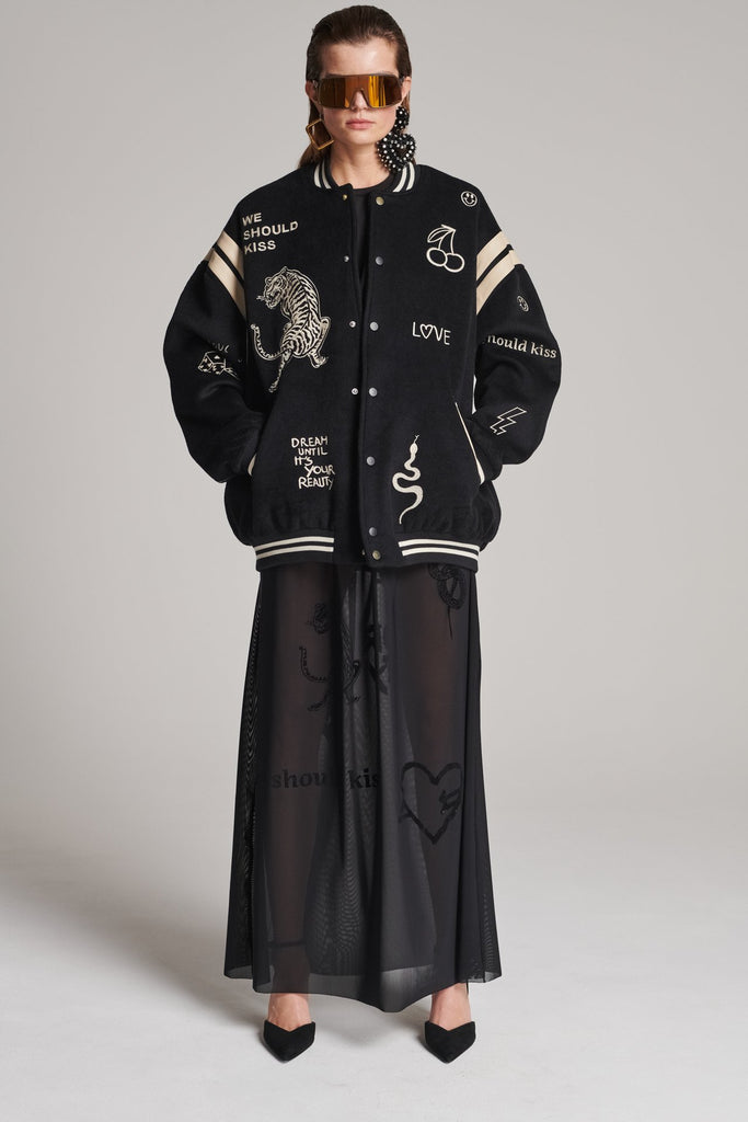Wide-shouldered baseball jacket. Features unique designs all-over, stamped logo on the back, press buttons, leather shoulder straps, pockets, elasticated cuffs and waistband. Fits oversized.