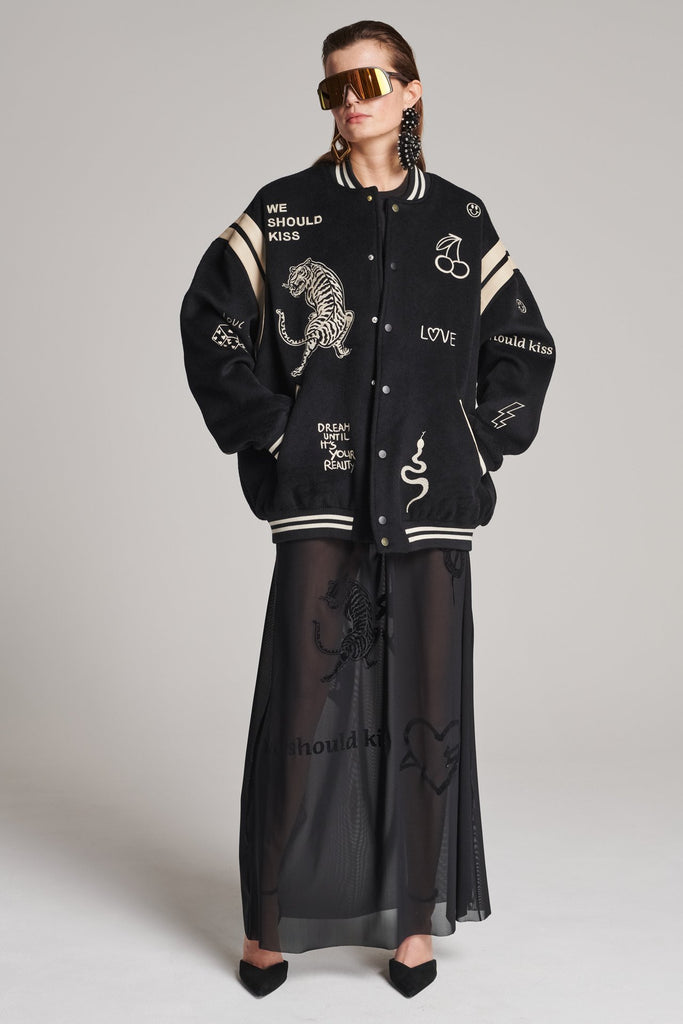 Wide-shouldered baseball jacket. Features unique designs all-over, stamped logo on the back, press buttons, leather shoulder straps, pockets, elasticated cuffs and waistband. Fits oversized.