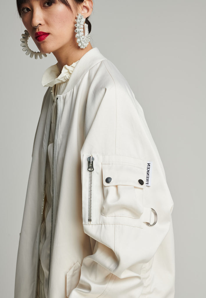 Satin bomber in off-white. Features batwing sleeves, front and arm pockets, zipper closure, and an wrinkled effect on the back. Fits oversize.