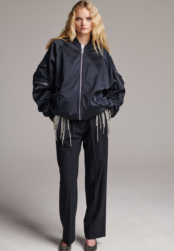 Oversized satin bomber jacket with batwing sleeve cut. Detailed with front and arm pockets, metallic zip closure and wrinkled pleat at the center back. This is the perfect winter shell and a true classic twist from FRENKEN.